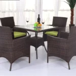 5-piece dark brown wicker patio dining set with green seat cushions, table without glass top