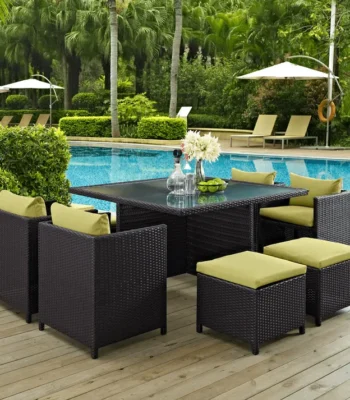 7-piece dark brown wicker outdoor dining set with green cushions, including ottoman and table without glass top