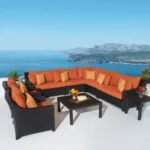 L-shape outdoor wicker rattan sectional sofa set with waterproof cushions, side table, and center table in dark brown and orange.