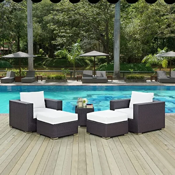 Dark brown and white outdoor rattan sofa set with matching ottoman and table, perfect for patio or garden seating.