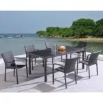 Black 7-piece wicker patio dining set with six chairs and a rectangular table on a patio.