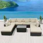 Outdoor black rattan sectional sofa set with cream cushions, seating 8, ideal for garden or patio.