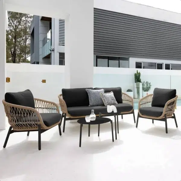 Outdoor garden 4-seater rope sofa with light grey cushions and dark grey woven rope frame placed on a patio.