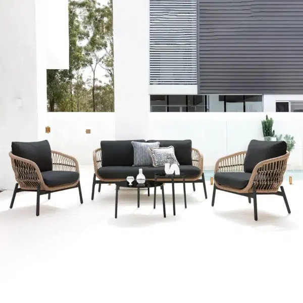 Outdoor garden 4-seater rope sofa with light grey cushions and dark grey woven rope frame placed on a patio.