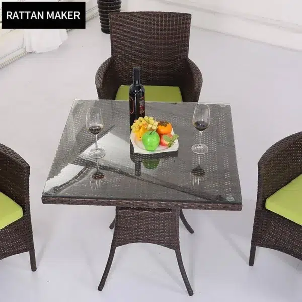5-piece dark brown wicker patio dining set with green seat cushions, table without glass top