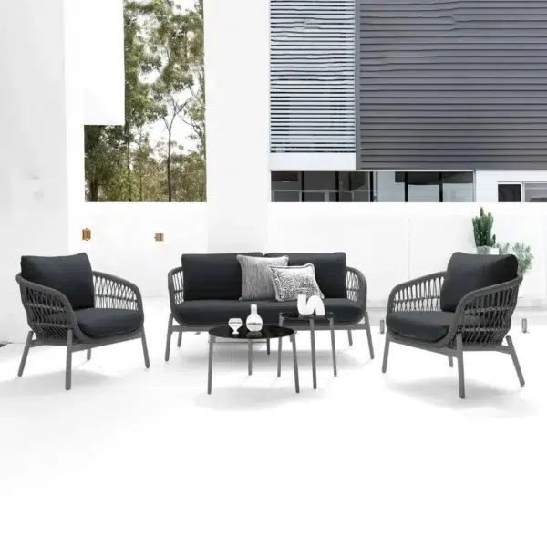 Outdoor garden 4-seater rope sofa with light grey cushions and dark grey woven rope frame placed on a patio.