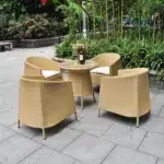 5-piece beige and white rattan patio conversation set with sofa, chairs, and table