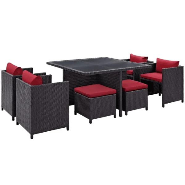 7 piece dark brown wicker outdoor dining set with red cushions, ottoman, and table without glass top.”