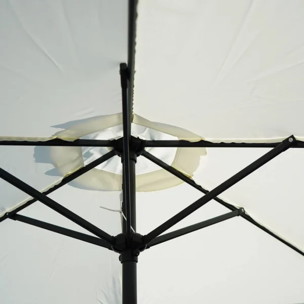 9ft off-white outdoor patio umbrella with center pole stand in a garden setting