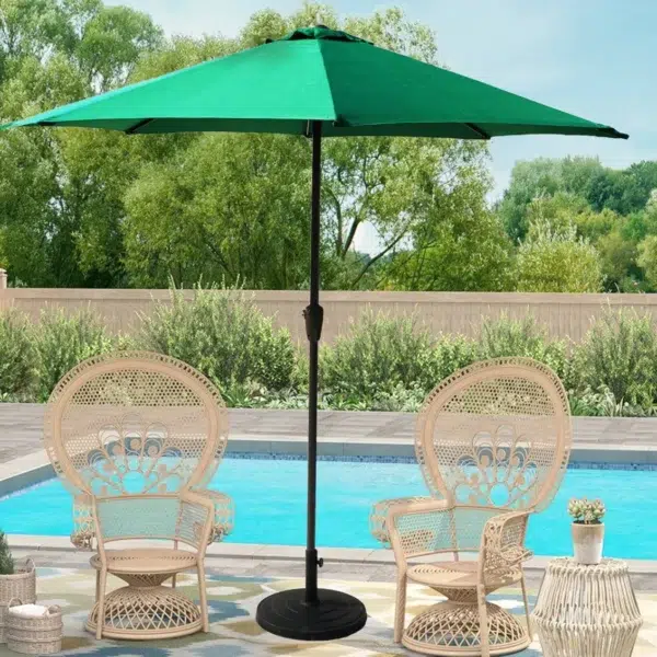 Green 9 Ft offset cantilever umbrella with marble base and crank handle by the poolside