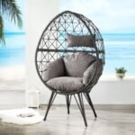 Black single seater swing basket hanging on a balcony with cushions