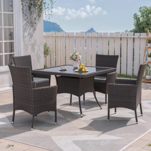 5-piece outdoor rattan dining set with grey cushions and dark brown armchairs, perfect for patio or garden