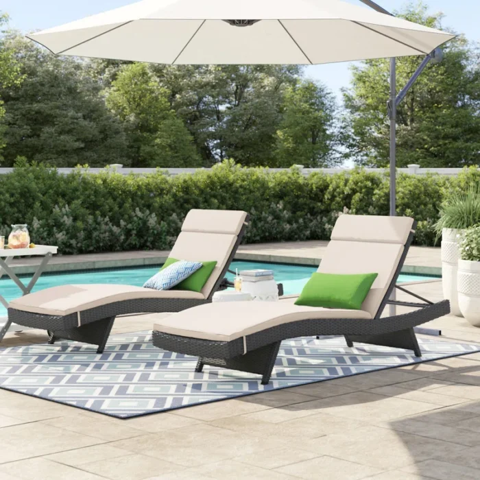 Set of 2 dark brown outdoor patio recliner lounge chairs with off-white all-weather cushions.