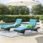 Set of 2 outdoor patio recliner lounger chairs in dark brown frame with sky blue all-weather cushions.