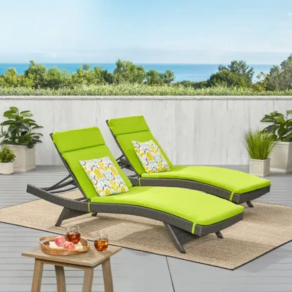 Pair of dark brown and green outdoor patio recliner lounger chairs with all-weather cushions.