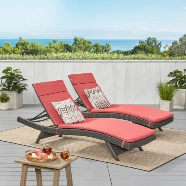 Set of 2 outdoor patio recliner lounger chairs in dark brown with red all-weather cushions.
