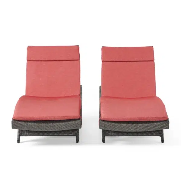Set of 2 outdoor patio recliner lounger chairs in dark brown with red all-weather cushions.