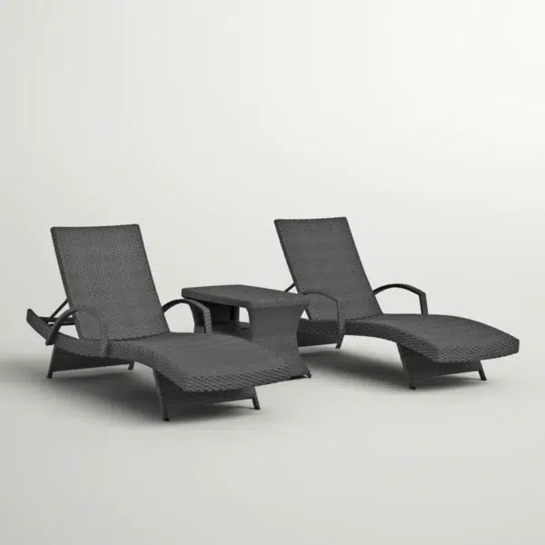Black outdoor chaise lounge set with matching side table on a patio with greenery in the background.
