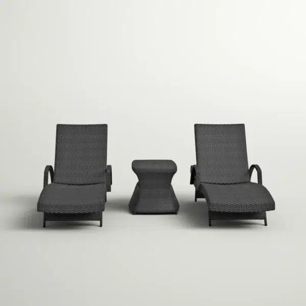 Black outdoor chaise lounge set with matching side table on a patio with greenery in the background.