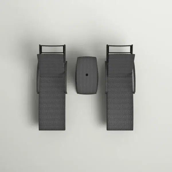 Black outdoor chaise lounge set with matching side table on a patio with greenery in the background.