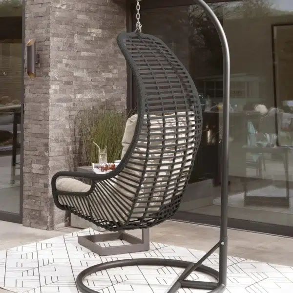 Single seater hanging swing with stand in black and beige, perfect for balcony or garden relaxation.
