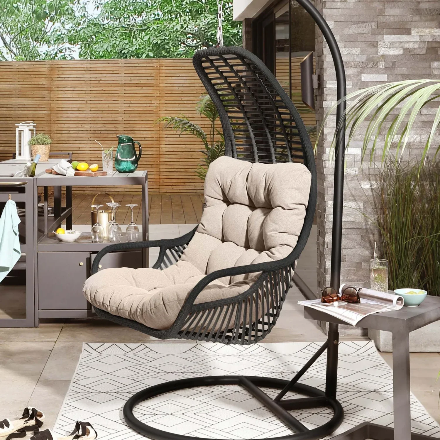 Single seater hanging swing with stand in black and beige, perfect for balcony or garden relaxation.