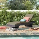 Beige wicker rattan outdoor patio chaise lounge chair with cushioned seat.