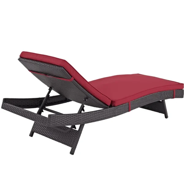 Add a pop of color and comfort to your patio with this stylish dark red wicker chaise lounge chair.