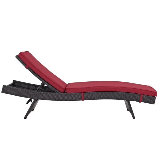 Add a pop of color and comfort to your patio with this stylish dark red wicker chaise lounge chair.