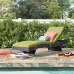Green wicker rattan outdoor patio chaise lounge chair with cushioned seat.