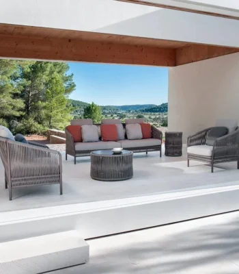 Outdoor 5-seater grey rope patio sofa set with center and side tables on a garden terrace, perfect for backyard and poolside lounging.