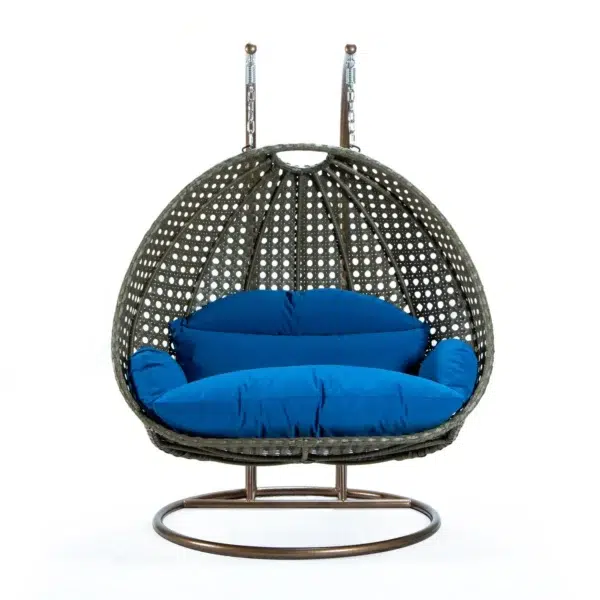 Double seater hanging swing chair in dark brown and blue, made of sturdy rattan with soft cushions, perfect for outdoor relaxation.