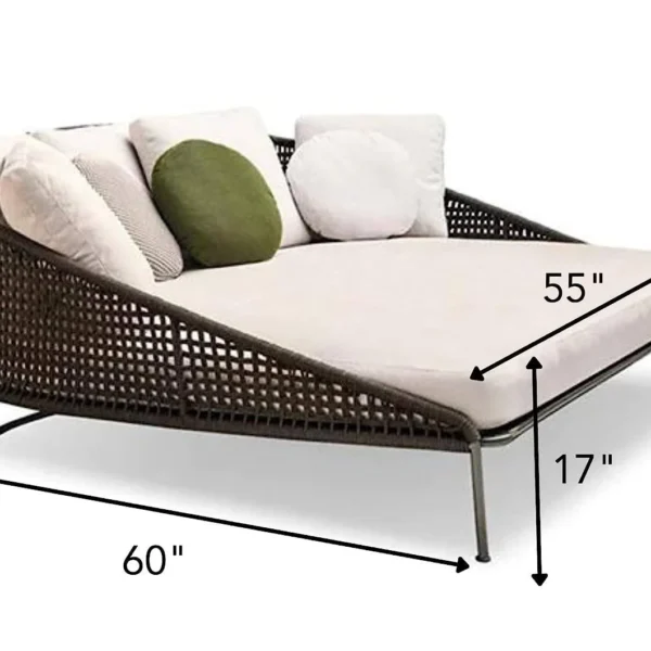 “Patio rope daybed set in dark brown frame with cream cushions, placed outdoors on a wooden deck surrounded by greenery.”