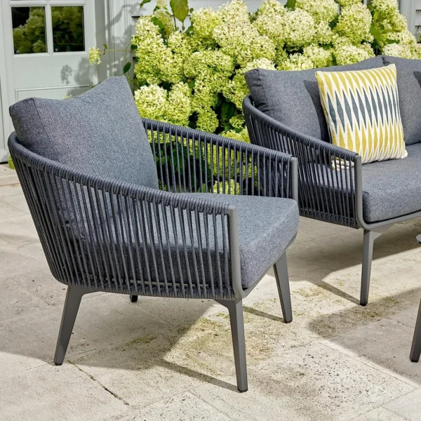 "Bring comfort and style to your patio or balcony with the Unique Design Rope Bistro Set. This 4-piece set includes two ergonomically designed chairs and a compact table, all crafted with durable rope detailing and a sleek grey finish. Ideal for small outdoor spaces, it combines modern aesthetics with practical functionality, making every coffee break or meal an inviting experience."
