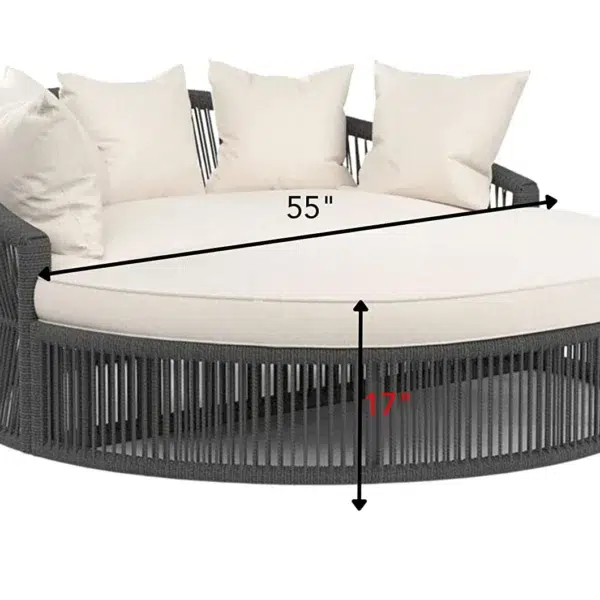 Round black daybed with cushions and low-profile table, styled for outdoor relaxation