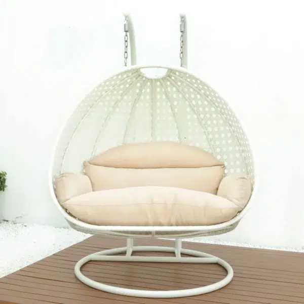 Double seater hanging swing chair in white and cream, suspended from a sturdy frame, perfect for indoor or outdoor relaxation.