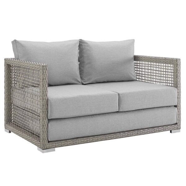 Outdoor 6-piece rattan wicker sectional sofa set in silver and grey, placed in a garden setting with cushions.