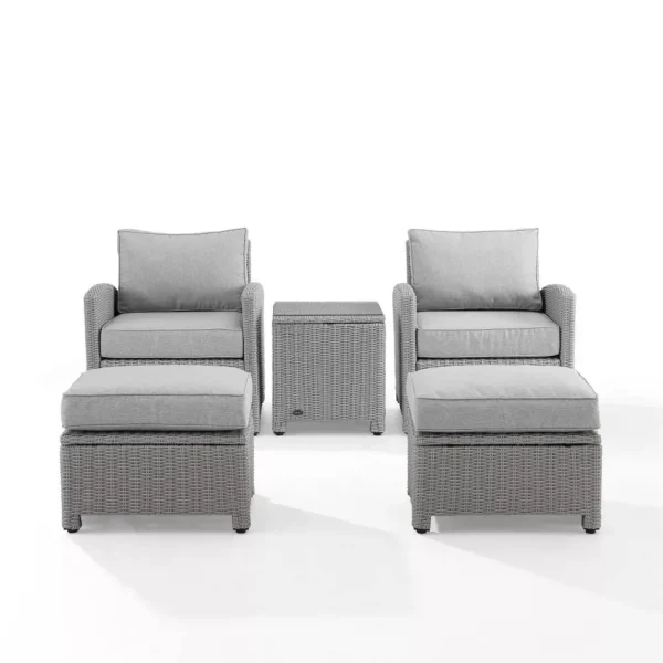 5-piece silver and grey patio furniture set with chairs, table, and cushions on a garden patio