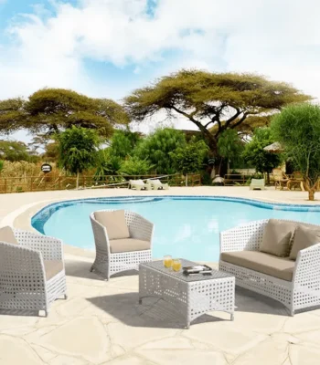Outdoor 4-seater sofa set with white and beige cushions, placed in a garden setting for relaxation.