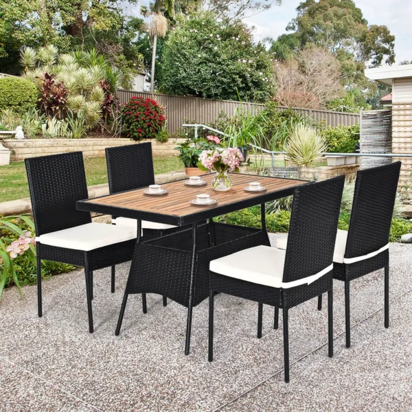 5-piece black and white rattan patio dining set with cushioned chairs and wooden tabletop