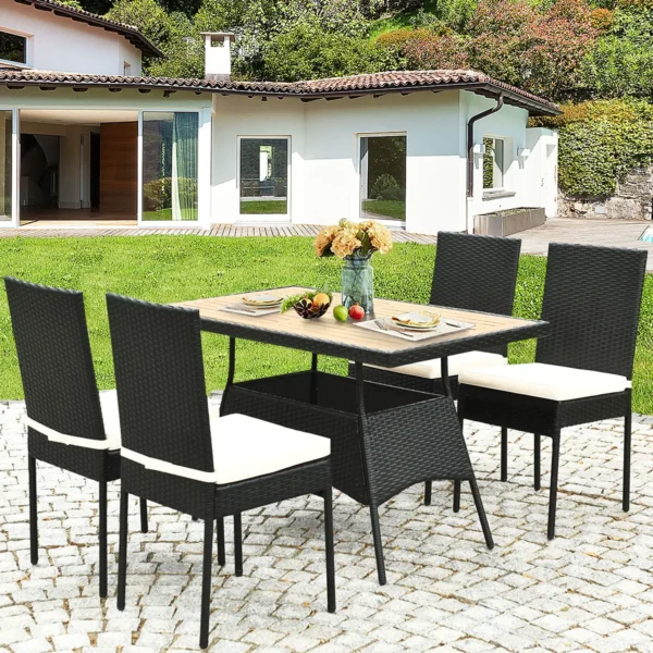 5-piece black and white rattan patio dining set with cushioned chairs and wooden tabletop