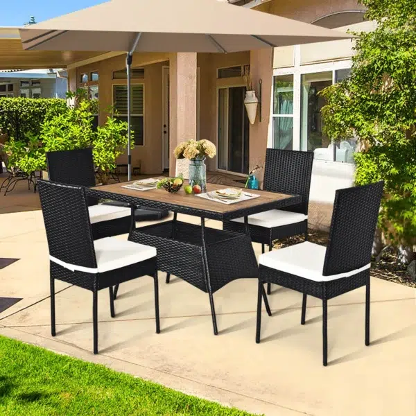 5-piece black and white rattan patio dining set with cushioned chairs and wooden tabletop