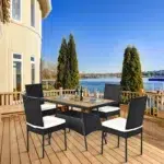 5-piece black and white rattan patio dining set with cushioned chairs and wooden tabletop