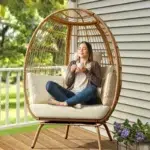 Beige single seater swing basket for balcony and garden with comfortable cushion.