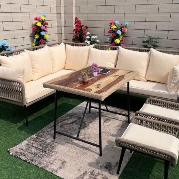 Rope patio sofa set with beige cushions and center table in outdoor garden setting