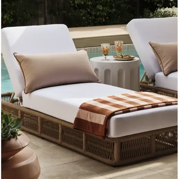 Two beige rope sun loungers with plush white cushions, perfect for outdoor relaxation.
