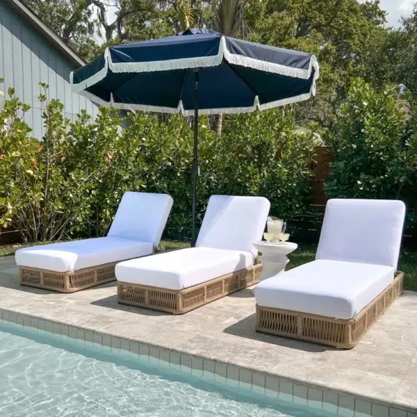 Two beige rope sun loungers with plush white cushions, perfect for outdoor relaxation.