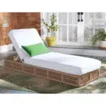 Beige rope sun lounger with a plush white cushion placed outdoors for comfortable lounging.