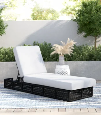 black rope sun lounger with soft white cushion for outdoor use.