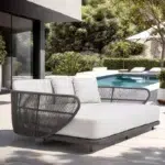 Outdoor braided rope patio daybed in black and off-white, perfect for relaxing in the garden or patio.